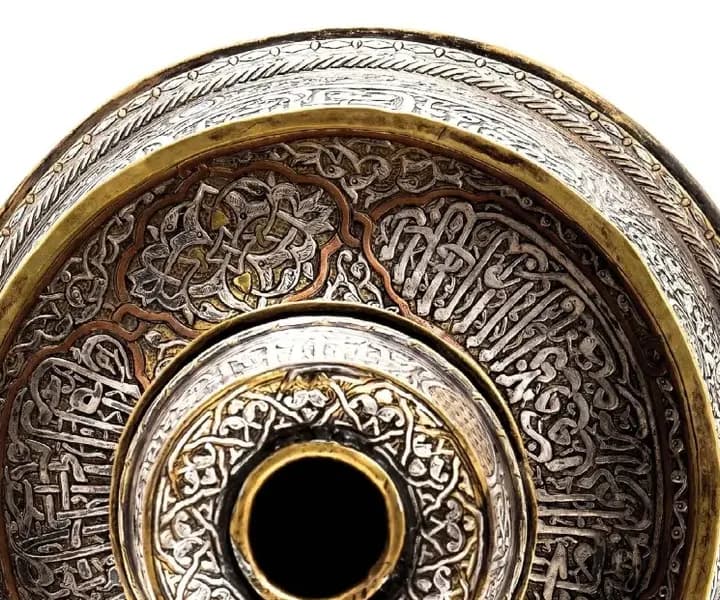 Concentric inscribed rings around a candlestick socket, seen from above